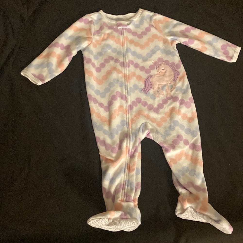 One piece with purple pink and blue and white pattern with a unicorn